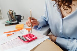 Woman calculating spousal support while holding a pencil in Dallas, TX