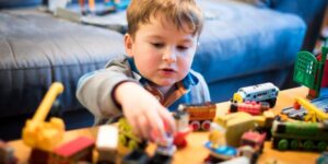 A young child plays with toys