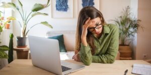 Woman stressed at her laptop