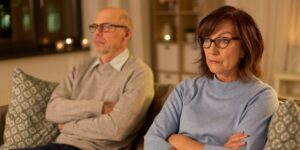 An older couple sitting on a couch