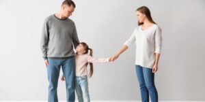 Divorced parents with their young child between them