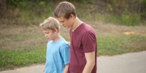 Older brother comforting younger brother