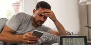 Upset man looking at his phone