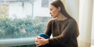 Woman staring sadly out a window